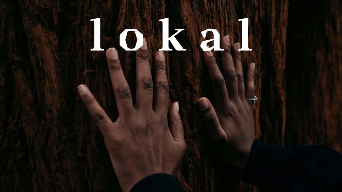 Woman’s hands resting on tree trunk with LOKAL company name overlay