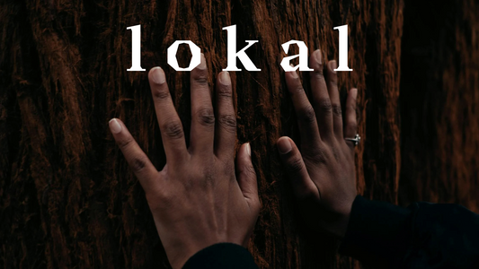 Woman’s hands resting on tree trunk with LOKAL company name overlay